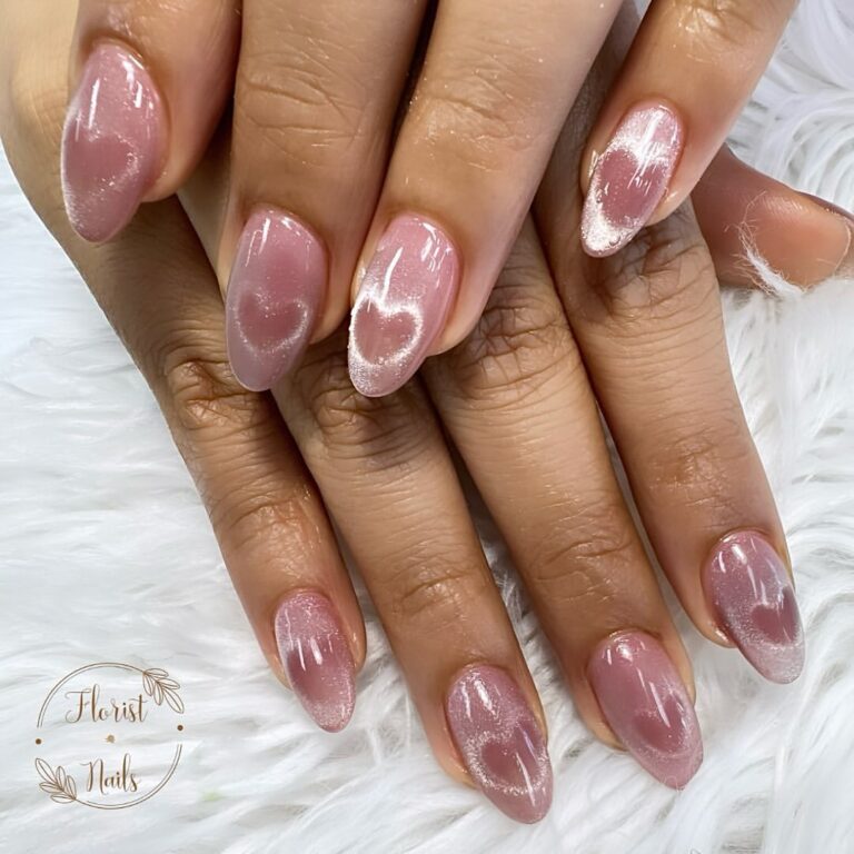 pink nails polished with cat eye polish and heart shape effect