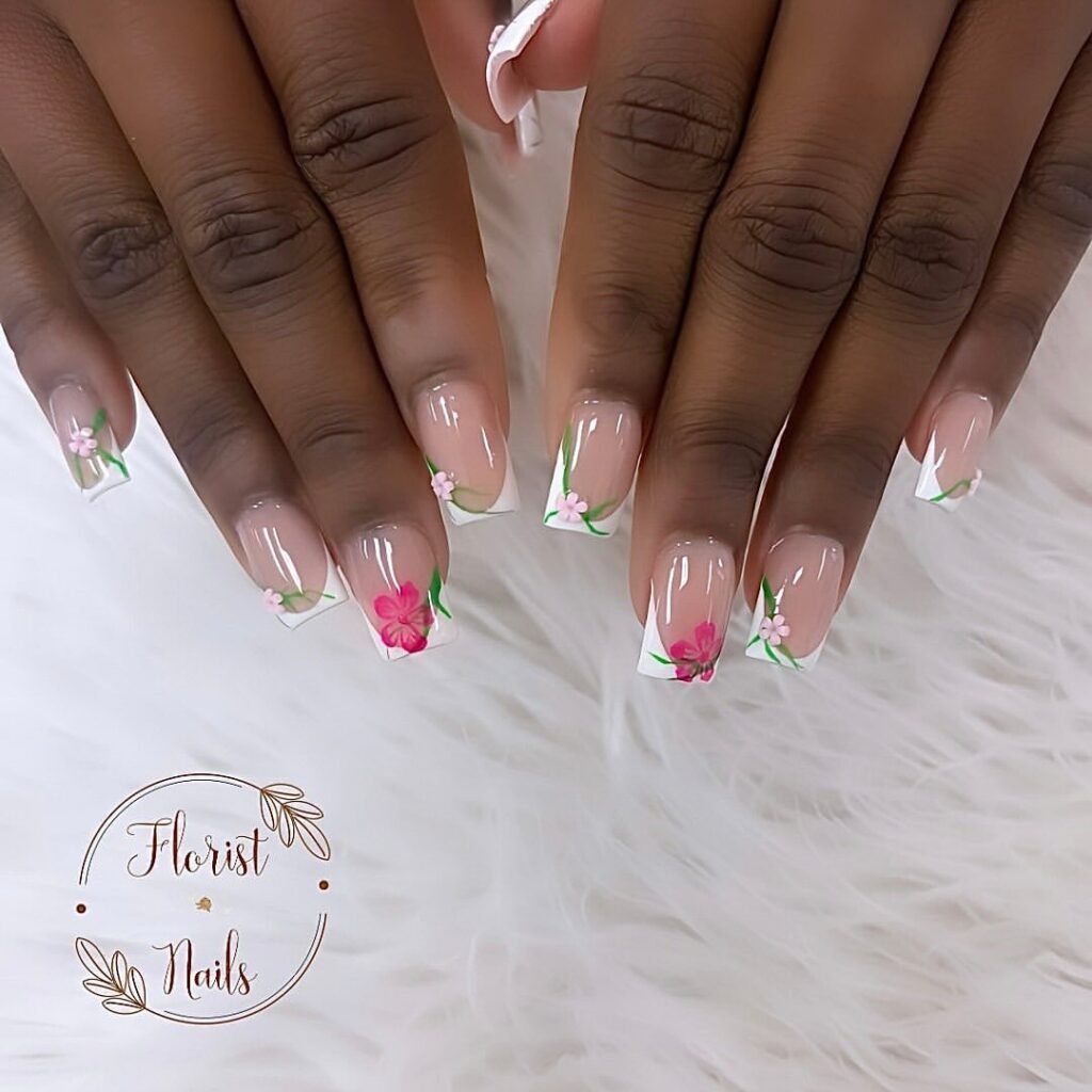 hands with nails designed with white French tips and flowers