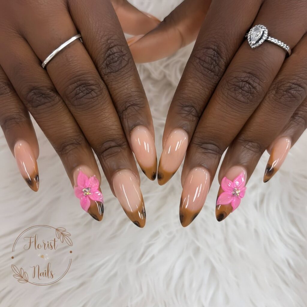 hands with nails designed in leopard French tips and flowers